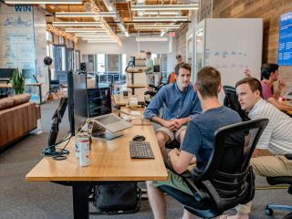 Professionals in a meeting, collaborating on strategy.